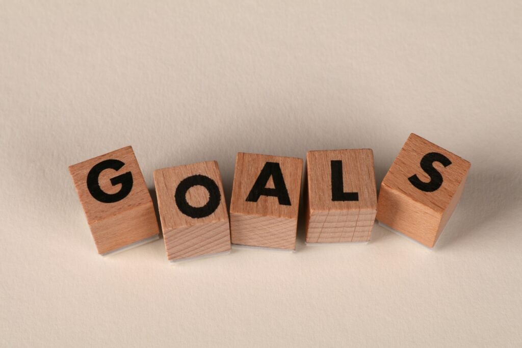 pexels-photo-32319627-32319627 Aligned wooden blocks spelling 'Goals' symbolize target achievement and ambition.